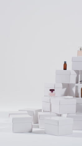 vertical video of beauty products with white cardboard boxes with copy space over white background