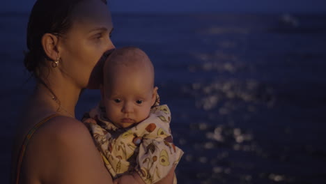 mom with baby on the beach at night