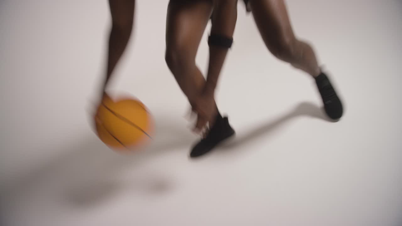 Close Up Studio Shot Of Male Basketball Player Dribbling And Bouncing Ball Against White Background 2
