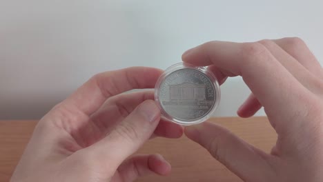 watch in hand silver vienna philharmonic coin. 1.5 euro coin.