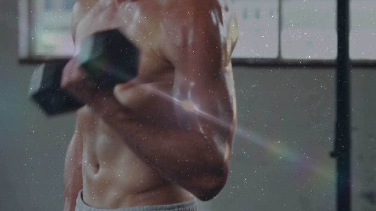 Male fitness model performing hex dumbbell curls camera sharpening lens flares showcasing torso