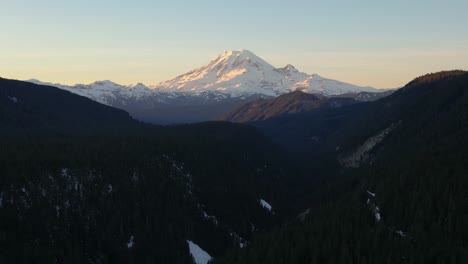 aerial view of mt. rainier at sunset, aerial ascending with forest