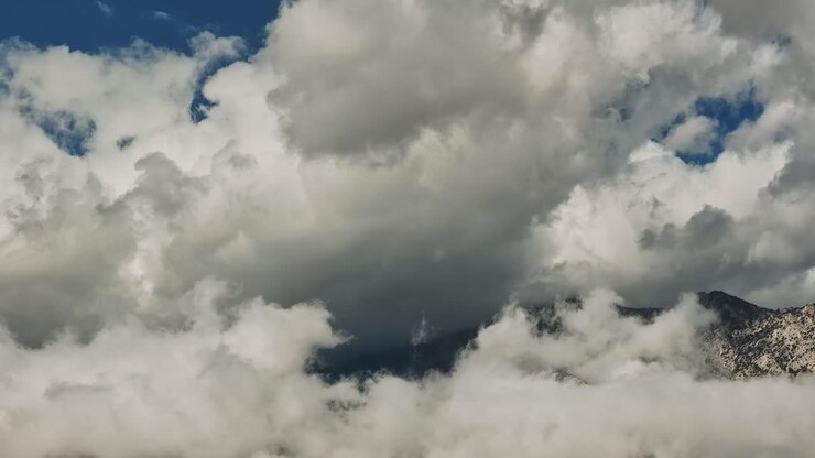 Clouds cover mountains during day in aerial view of USA