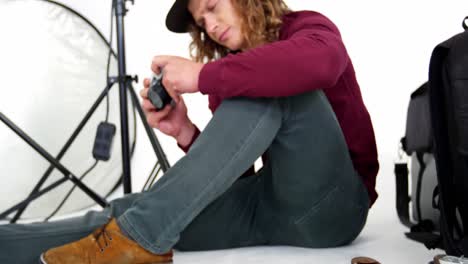 Photographer-looking-at-photos-on-digital-camera