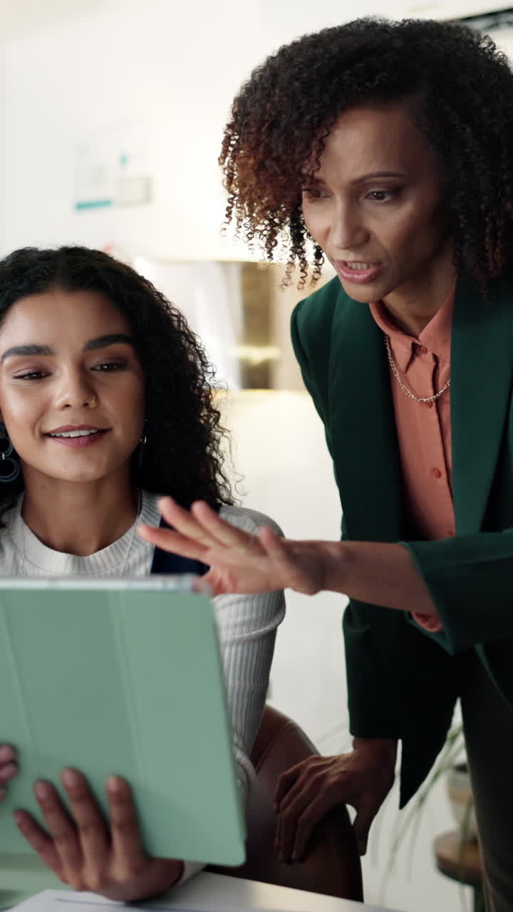 Businesswomen collaborating in the office using a tablet