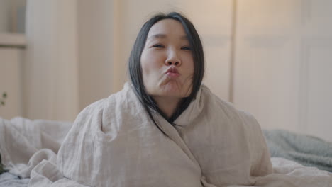 woman smiling in bed