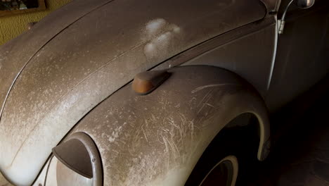 Dusty-beetle-parked-in-the-garage-for-many-years,-pan-shoot