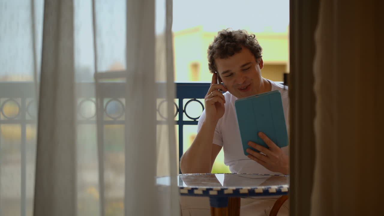 Man busy with phone talk and touchpad