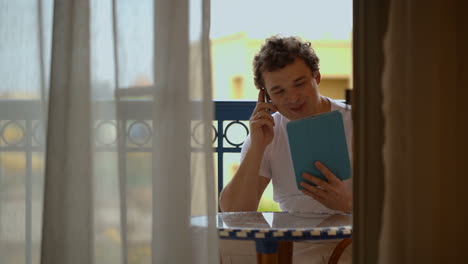 Man-busy-with-phone-talk-and-touchpad