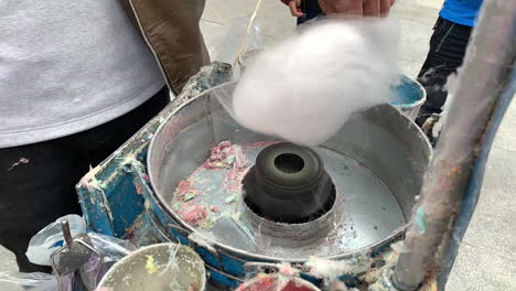 man making cotton candy on the street