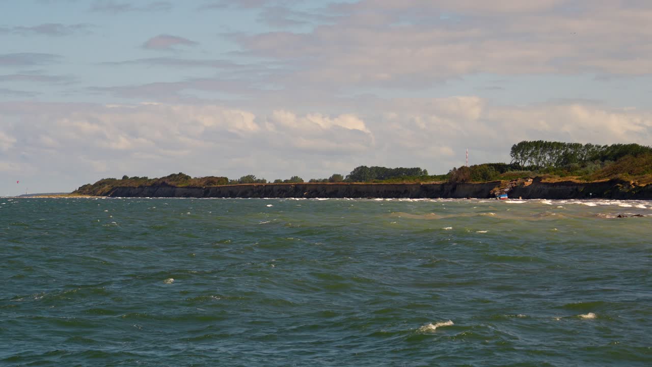 Baltic Sea coast in warm sunlight with light waves