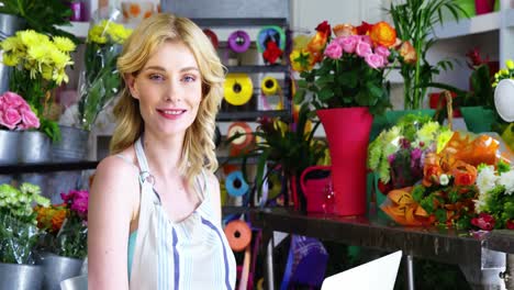 female florist using laptop in florist shop