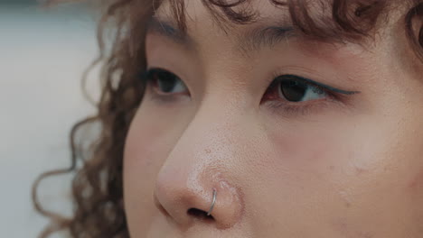 close-up portrait of a woman with nose ring and makeup