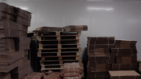 cardboard packaging and labeled boxes neatly stacked in a warehouse