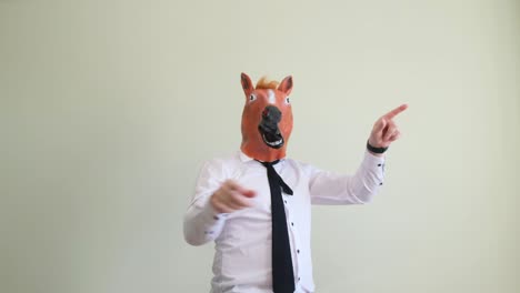 crazy man dancing in horse mask on background in studio crazy man dancing in horse mask on background in studio