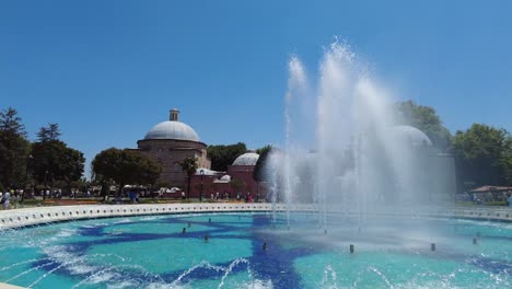 fountain and historical buildings in a park