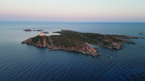faro en una pequeña isla durante la puesta de sol en cerdeña, italia - antena 4k