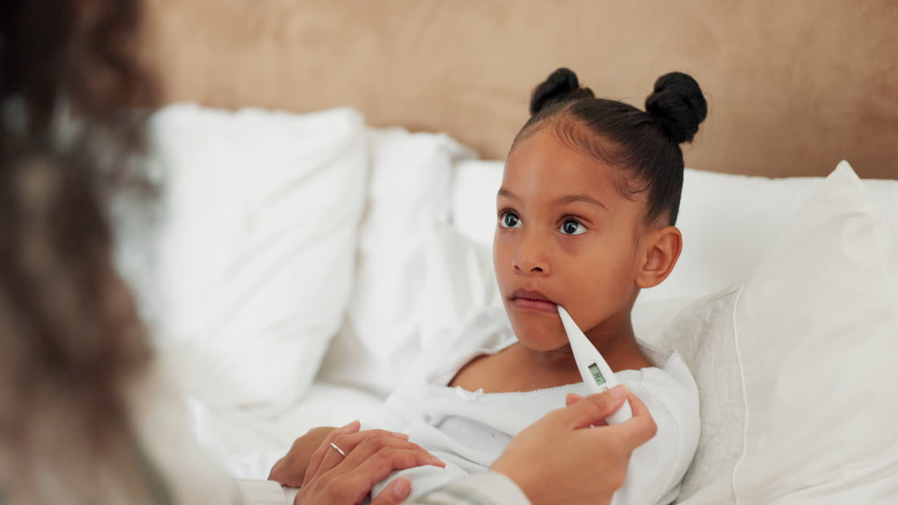 Sick child, bed and mother with a thermometer to