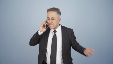 angry talking businessman on the phone.