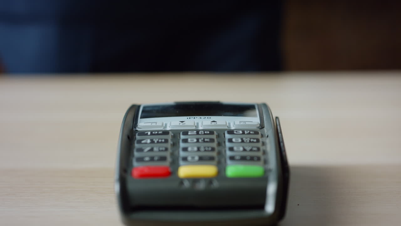 Hands making contactless payment with credit card at machine terminal close up.