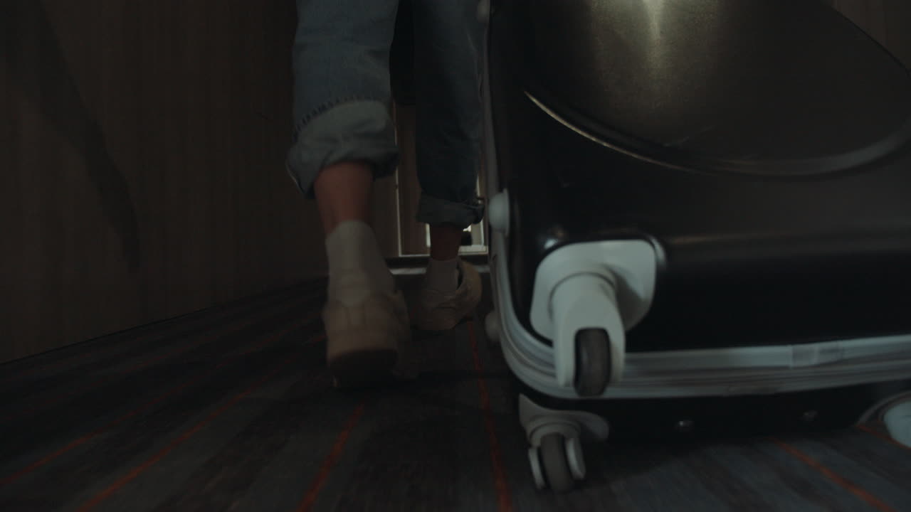 Unknown man walking with suitcase