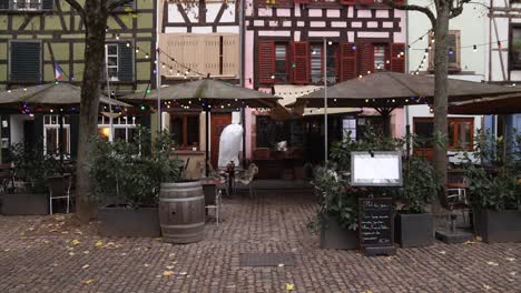 cute cafes in town plaza at festive christmas market in strasbourg, france europe