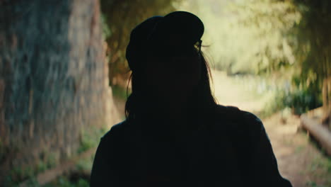woman walking through a tunnel