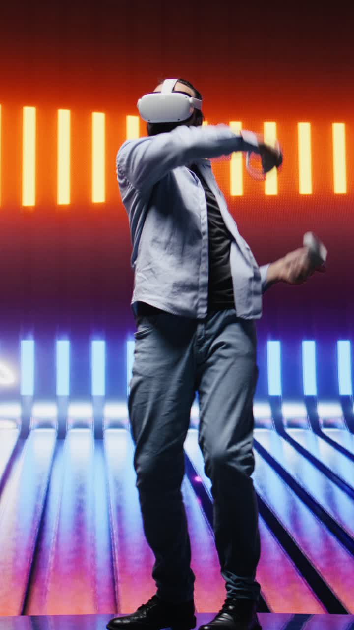Vertical Video Modern man in a neon lit night scene using VR high tech glasses