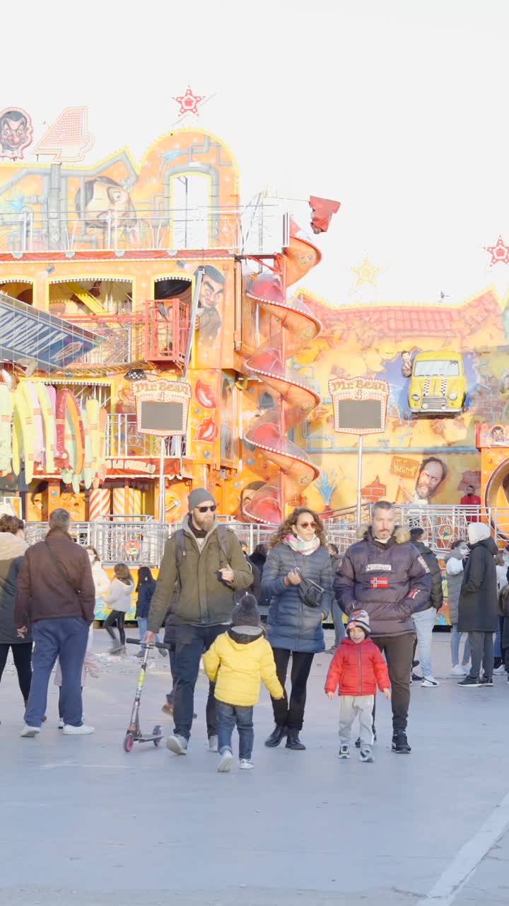 People Enjoying an Amusement Park with a Mr. Bean Themed Ride