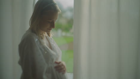 pregnant woman stroking belly