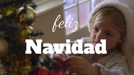 a girl smiles and decorates a christmas tree in her living room