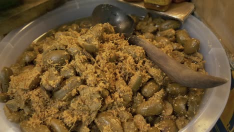 salt-seasoned-olive-with-yellow-ginger-at-asian-street-food-market-booth-for-sale-documentary