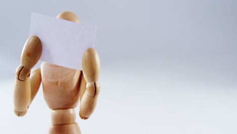 figurine holding blank placard