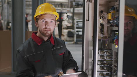 portrait of engineer near electric panel