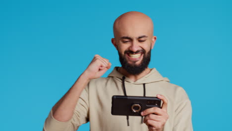middle eastern adult enjoying video games challenge in studio