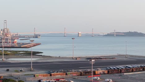 a lockdown aerial view of the san francisco bay bridge in the distance.