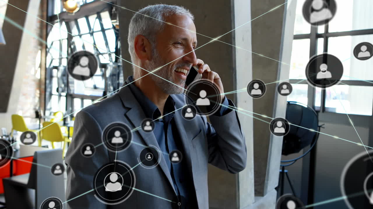 Animation of network of connections with icons over biracial businessman talking on smartphone