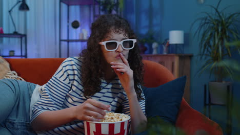 woman watching tv with popcorn