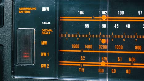 tuning analog radio dial frequency on scale of the vintage receiver