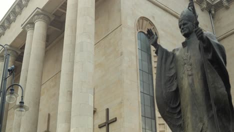 a renovated, historic church with a pope sculpture in poland