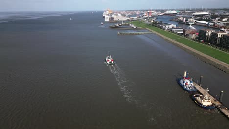 tug-boat-on-its-way-to-a-cruise-ship-port,-Bremerhaven,-germany,-europe,-drone,-north-sea