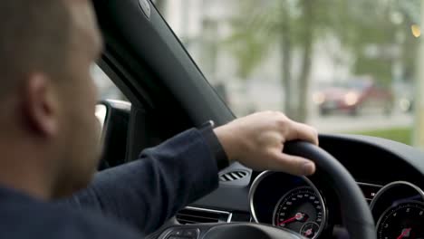 man driving a car in the city