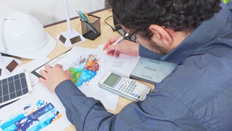 financial analyst calculating the budget for a green tech project