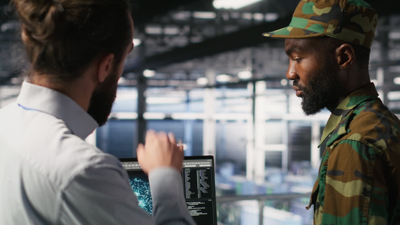 Military server room IT professionals using AI LLM tech on laptop