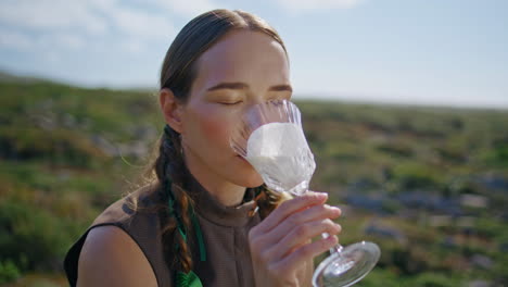 closeup girl tasting milk with dairy mustache. relaxed model resting countryside