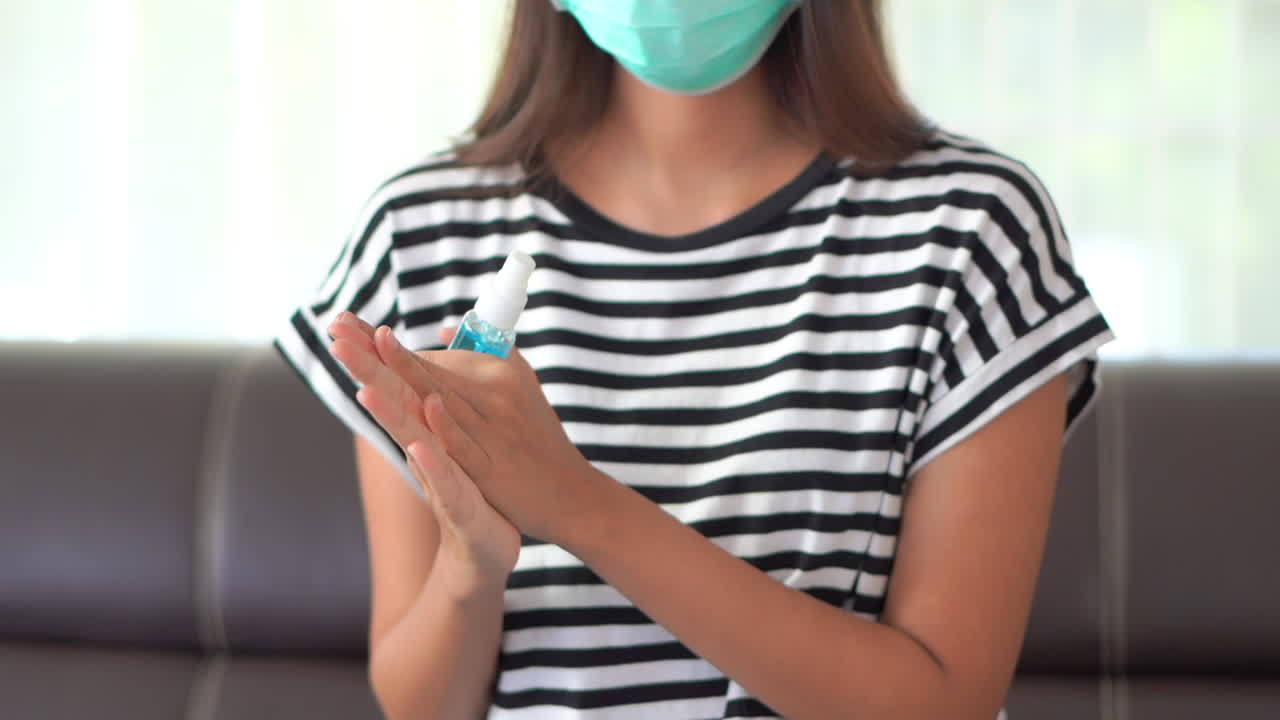 Close up woman's hands washing with alcohol spray sanitizer to prevent the spread of germs, bacteria and avoid infections virus. Hygiene, concept