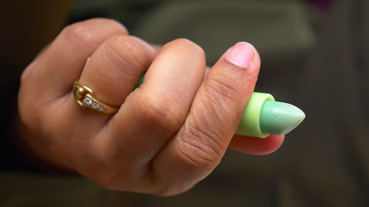 Hand holding a lipstick
