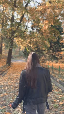 woman walking in autumn park