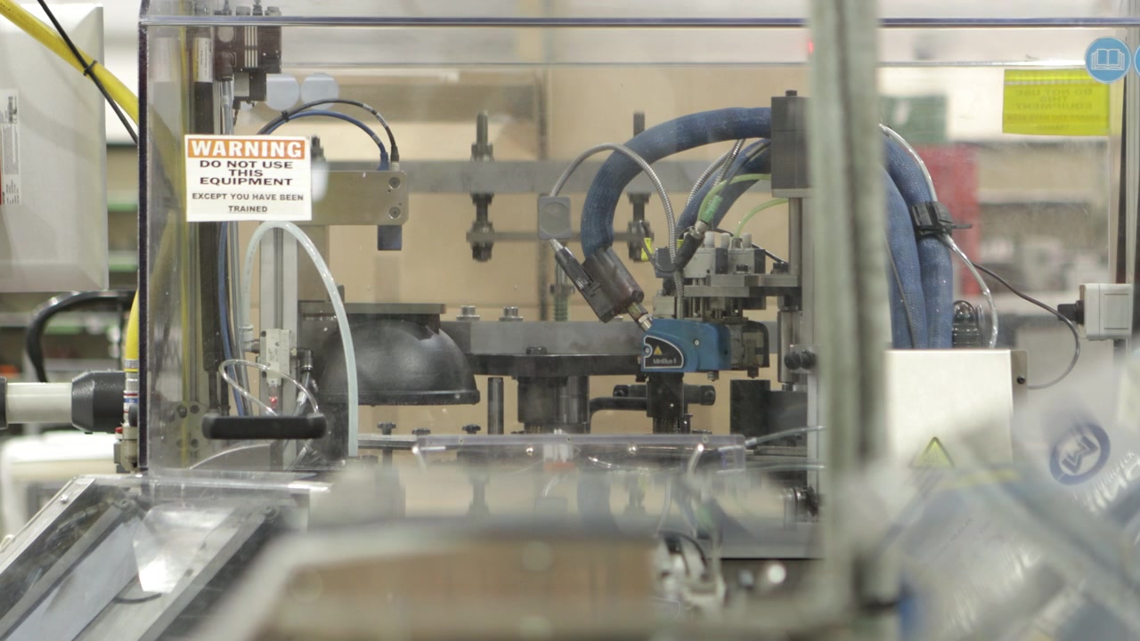 Cap lining machine working in industrial factory, static view