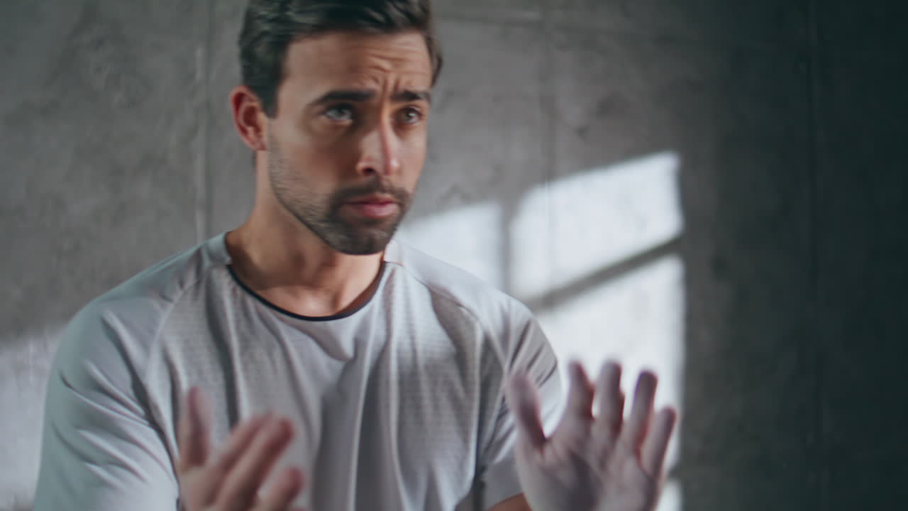 Male athlete rubbing hands with magnesium. Closeup sportsman using talc powder